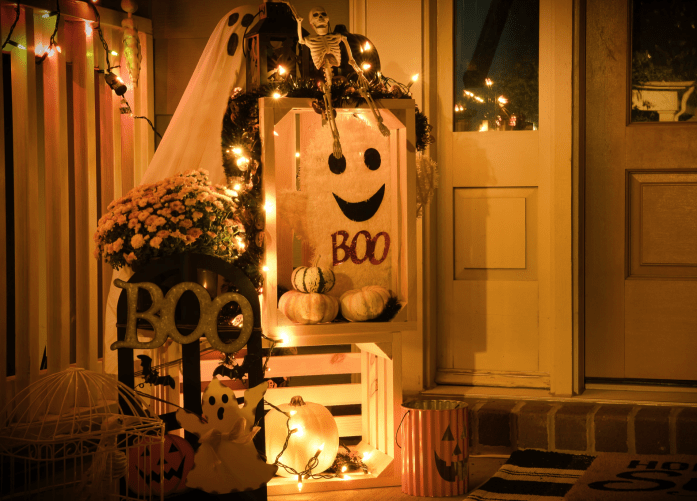 Orange hued image of Halloween decorations at a front door